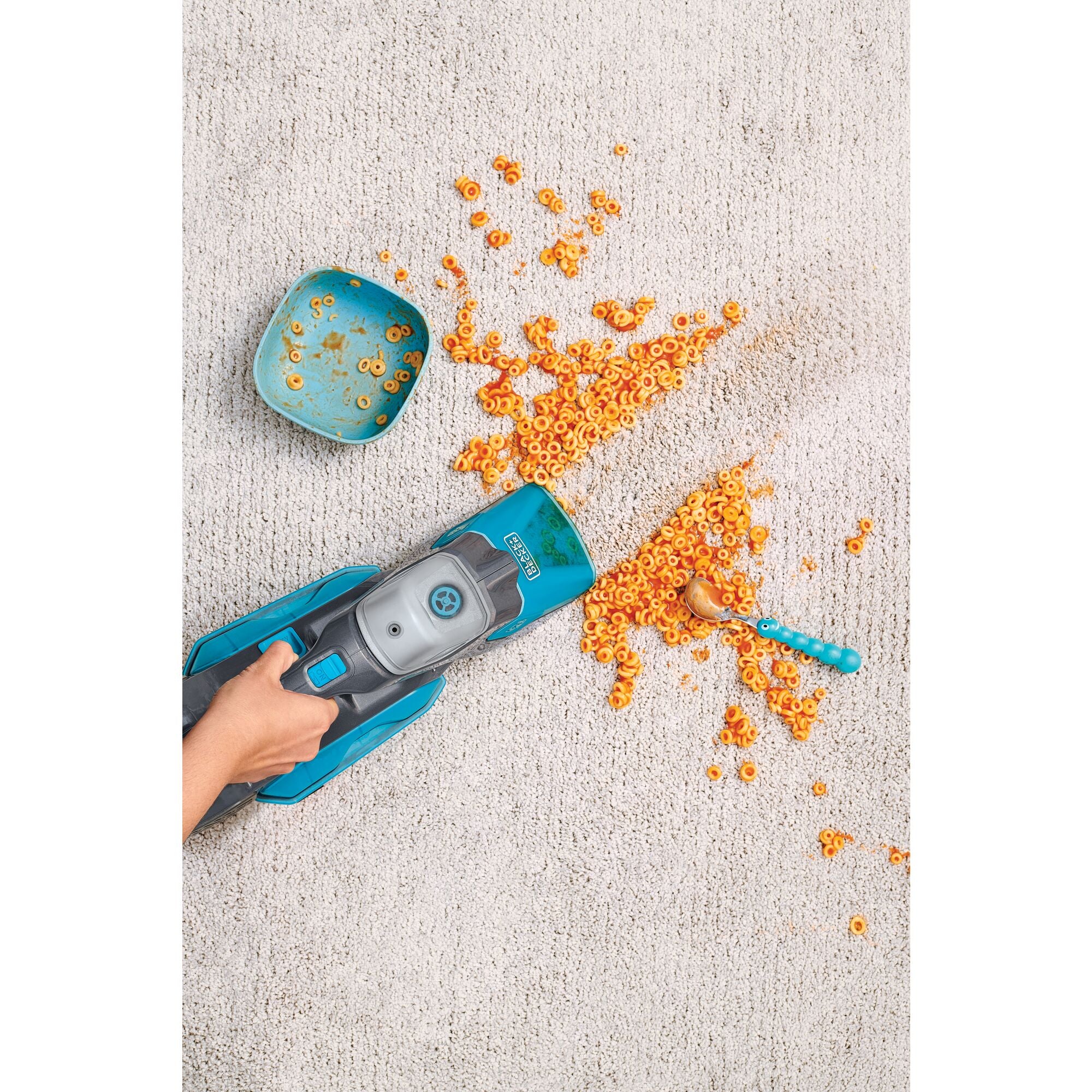 BLACK+DECKER spillbuster™ Cordless Spill and Spot Cleaner cleaning the spilled pasta from the floor.