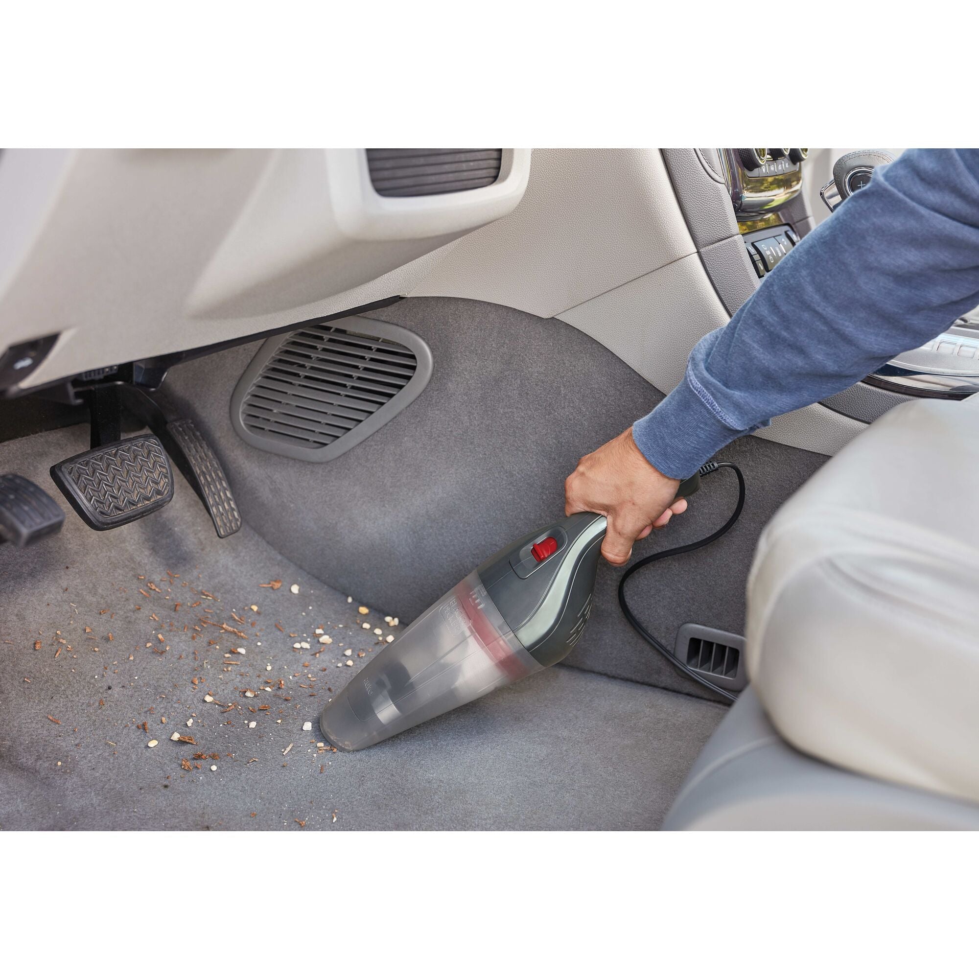 Black and decker handheld vacuum for car being used.