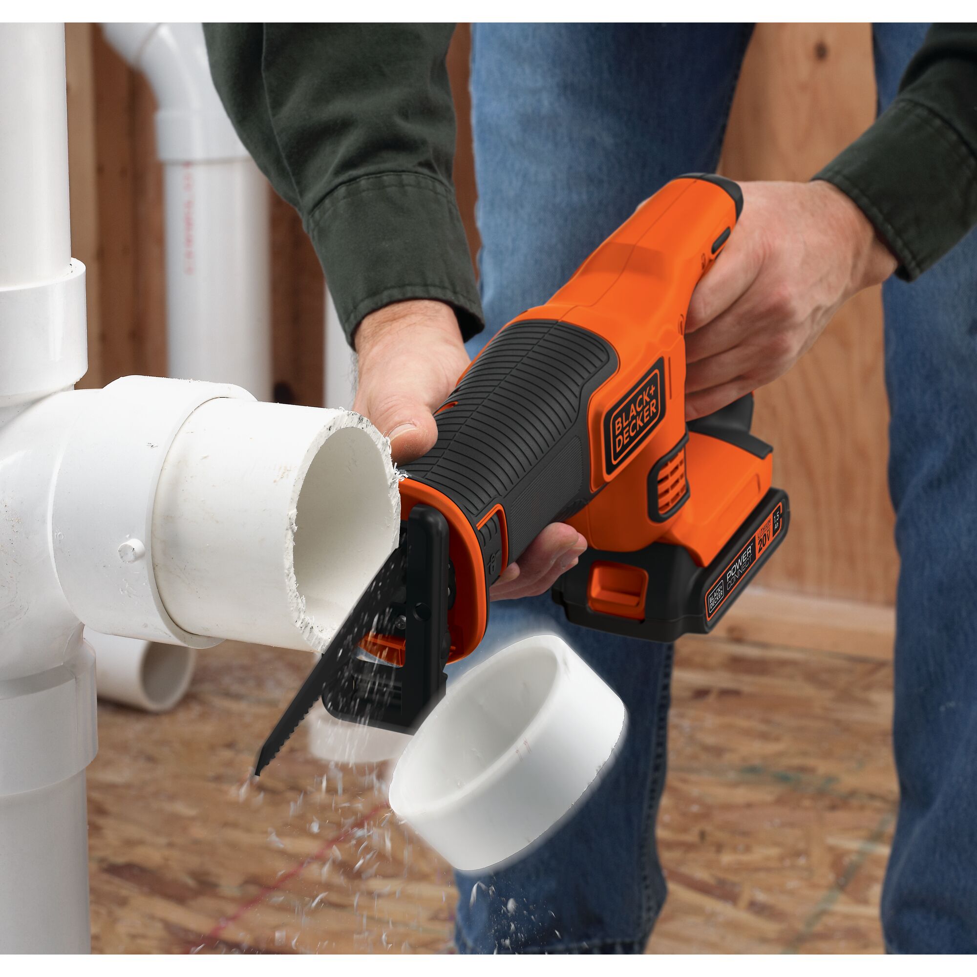 A person cutss a pipe with the BLACK+DECKER 20V MAX* Cordless Reciprocating Saw Kit. Powerful and versatile cuts through wood, metal, plastic, rubber, and more.