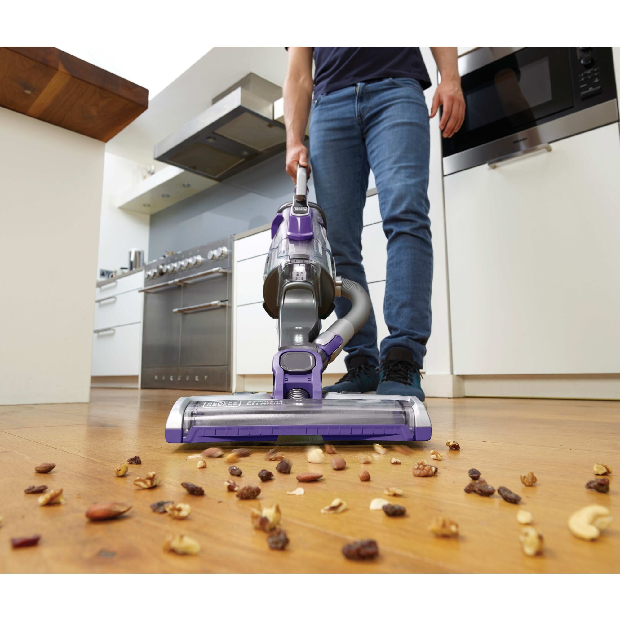 Powerseries pro cordless 2 in 1 pet vacuum being used by a person.