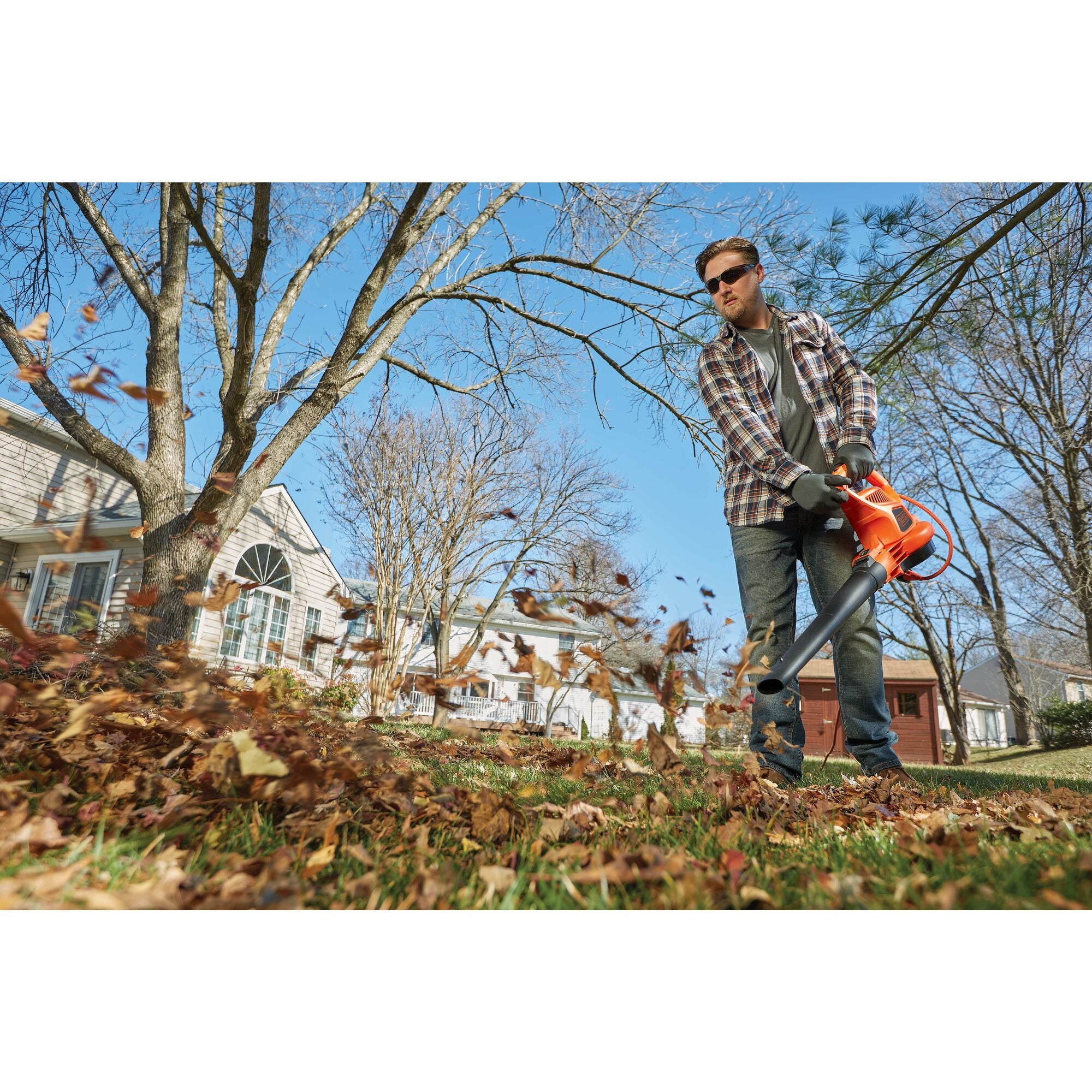 3 in 1 VAC PACK 12 Amp leaf blower, vacuum, and mulcher being used by a person to pick up leaves in yard. 