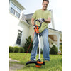 A man is using a BLACK+DECKER String Trimmer for trimming the grass in the garden.