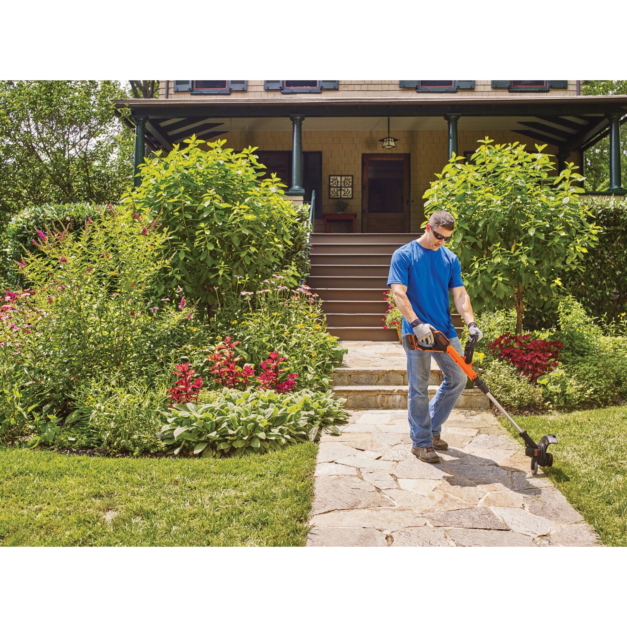 20 volt MAX Lithium 12 inch Trimmer / Edger being used on the ground outdoor by a person.