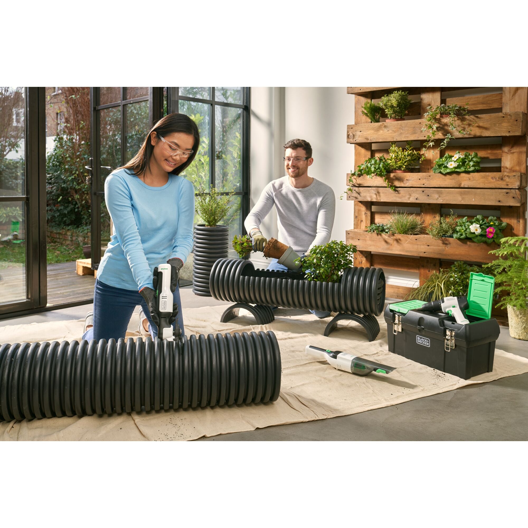 Woman cleaning sofa with the BLACK+DECKER reviva hand vac