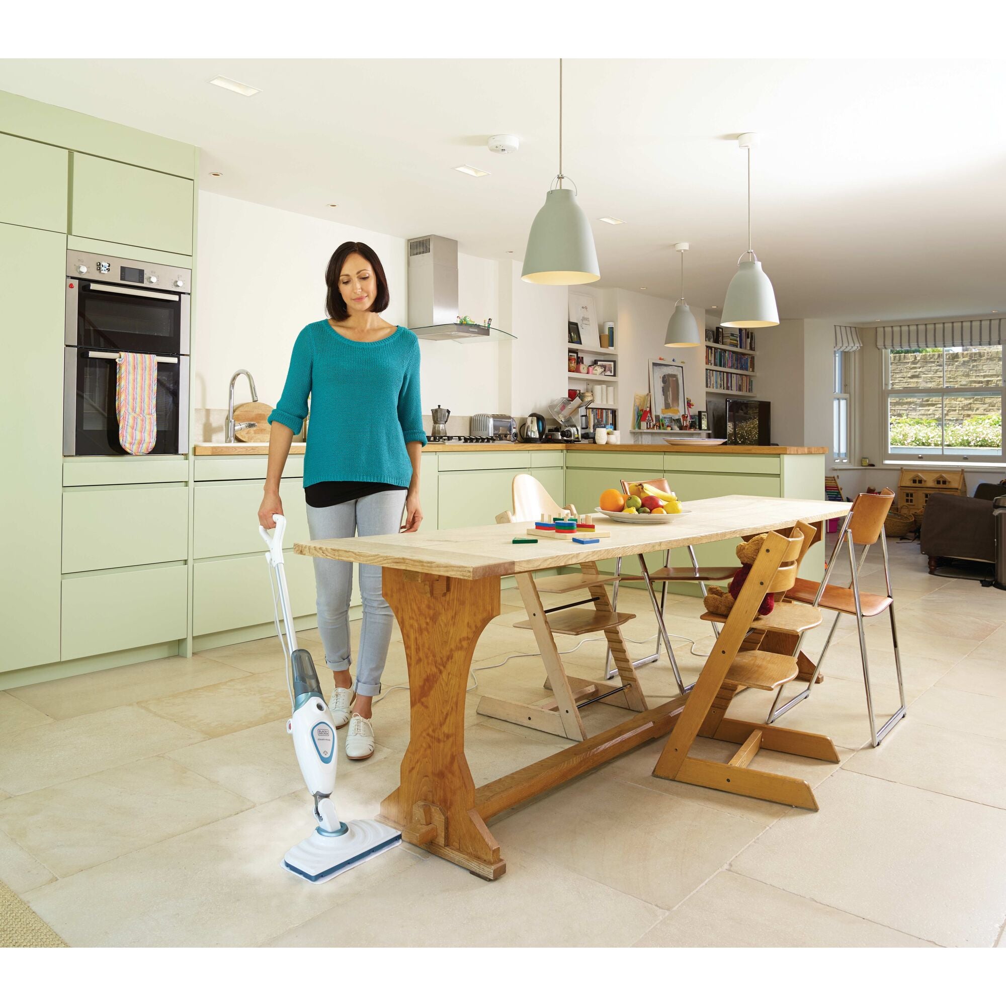 Steam mop with lift plus reach head being used by a person to clean floor.