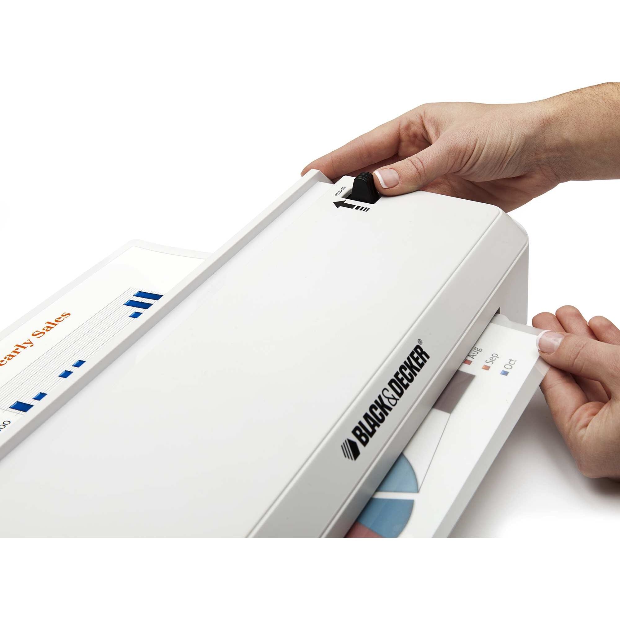 Flash 9.5 inch thermal laminator being turned on by a person.