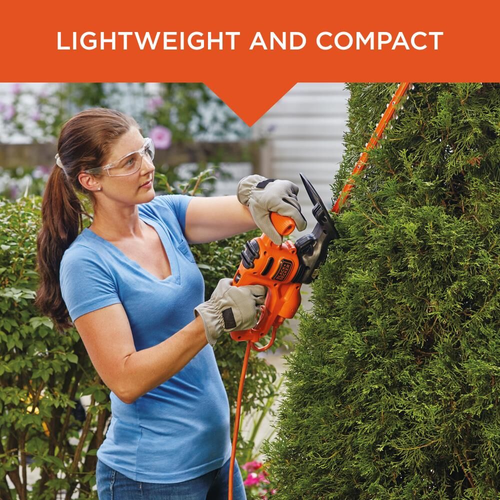 17 inch Electric Hedge Trimmer being used by person to trim hedge outdoors.