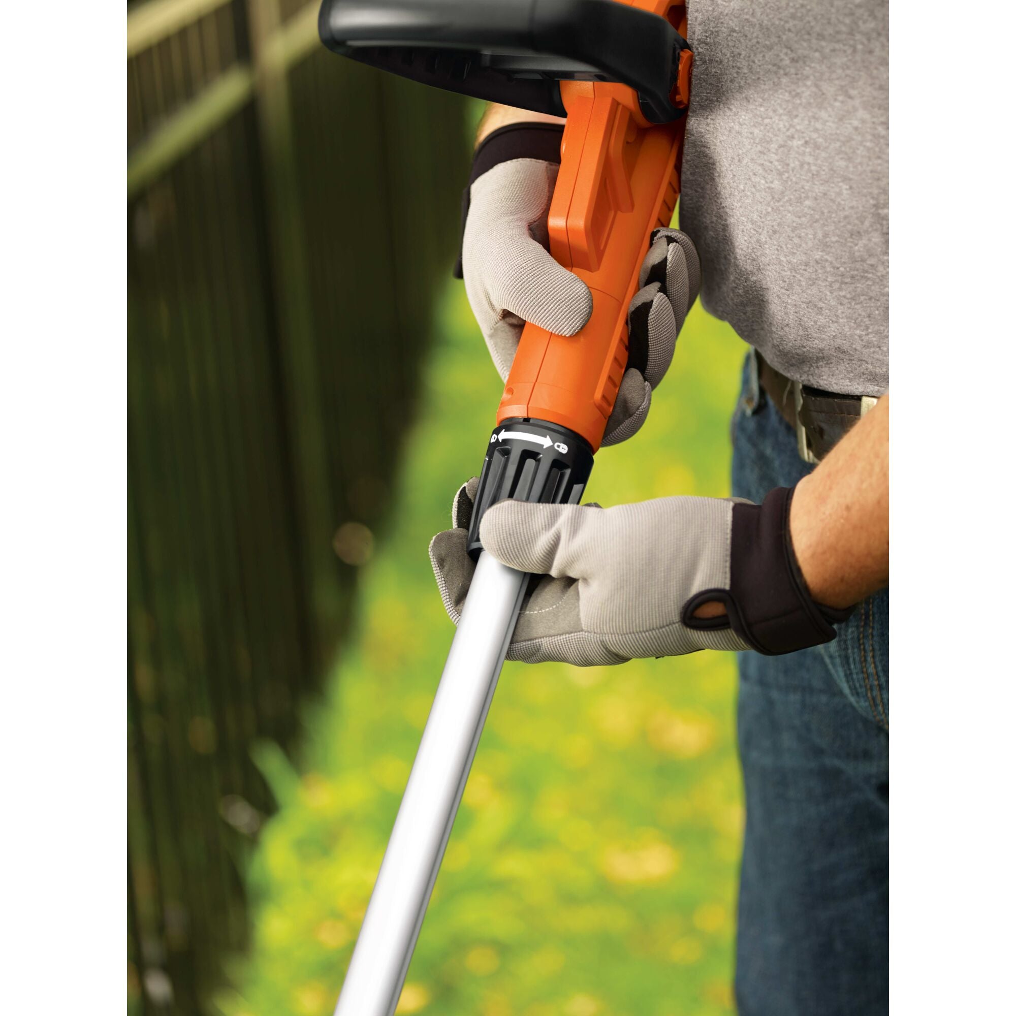 Trimmer / edger being used by a person to trim grass.\n\n