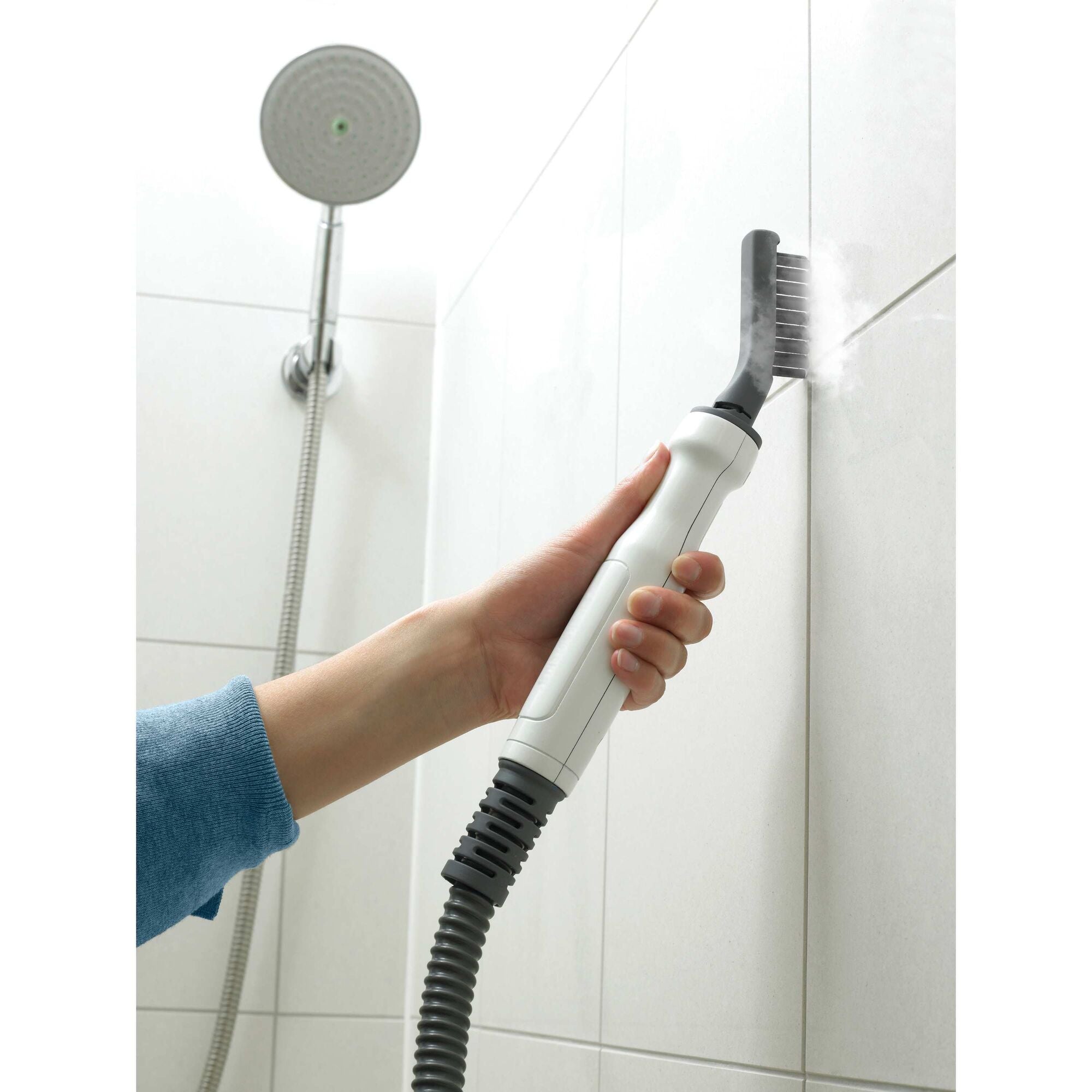 BLACK+DECKER SteamMop™ And Portable Steamer cleaning the space between the bathroom wall tiles.