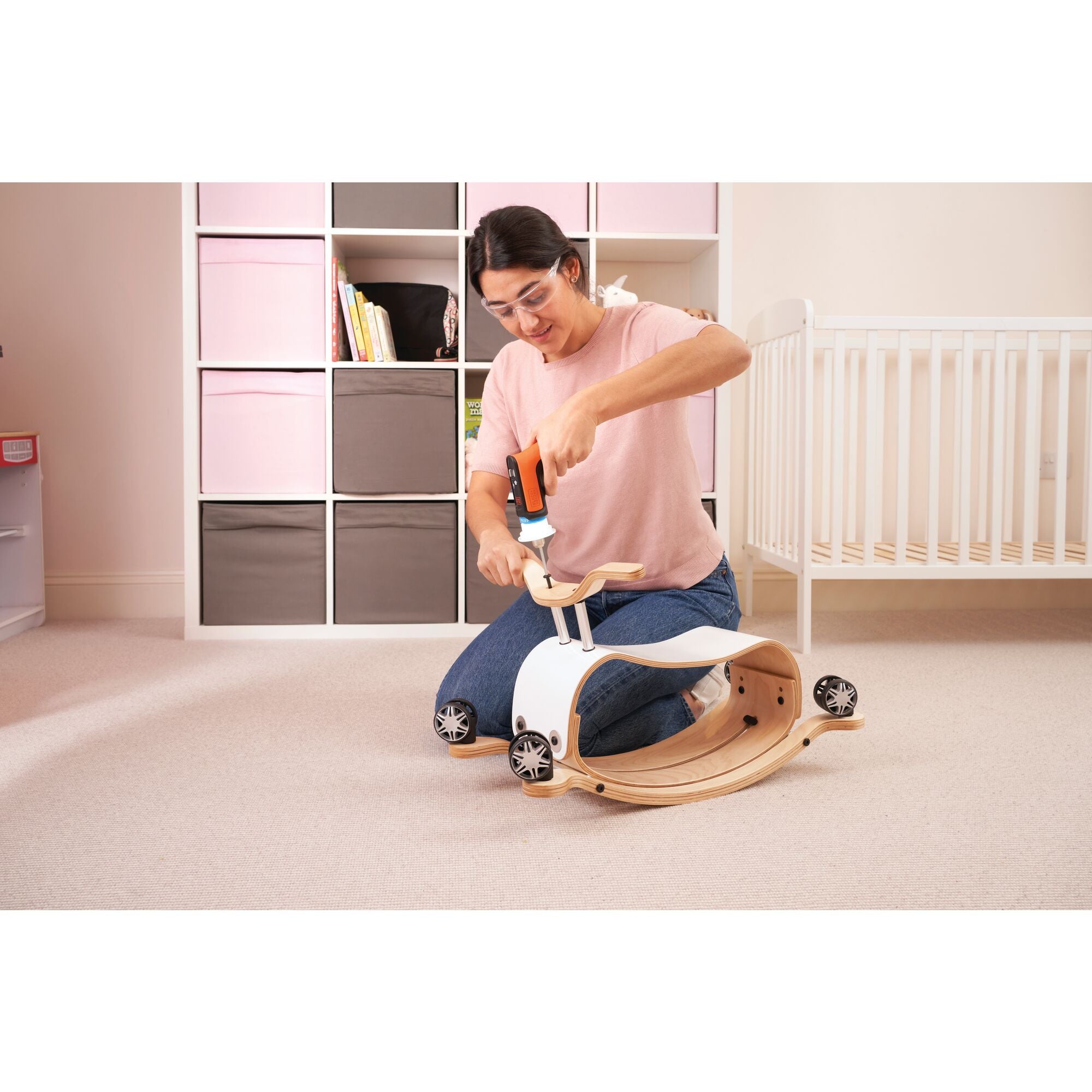 HEXDRIVER cordless furniture assembly tool screwdriver being used by a person to assemble wooden furniture.