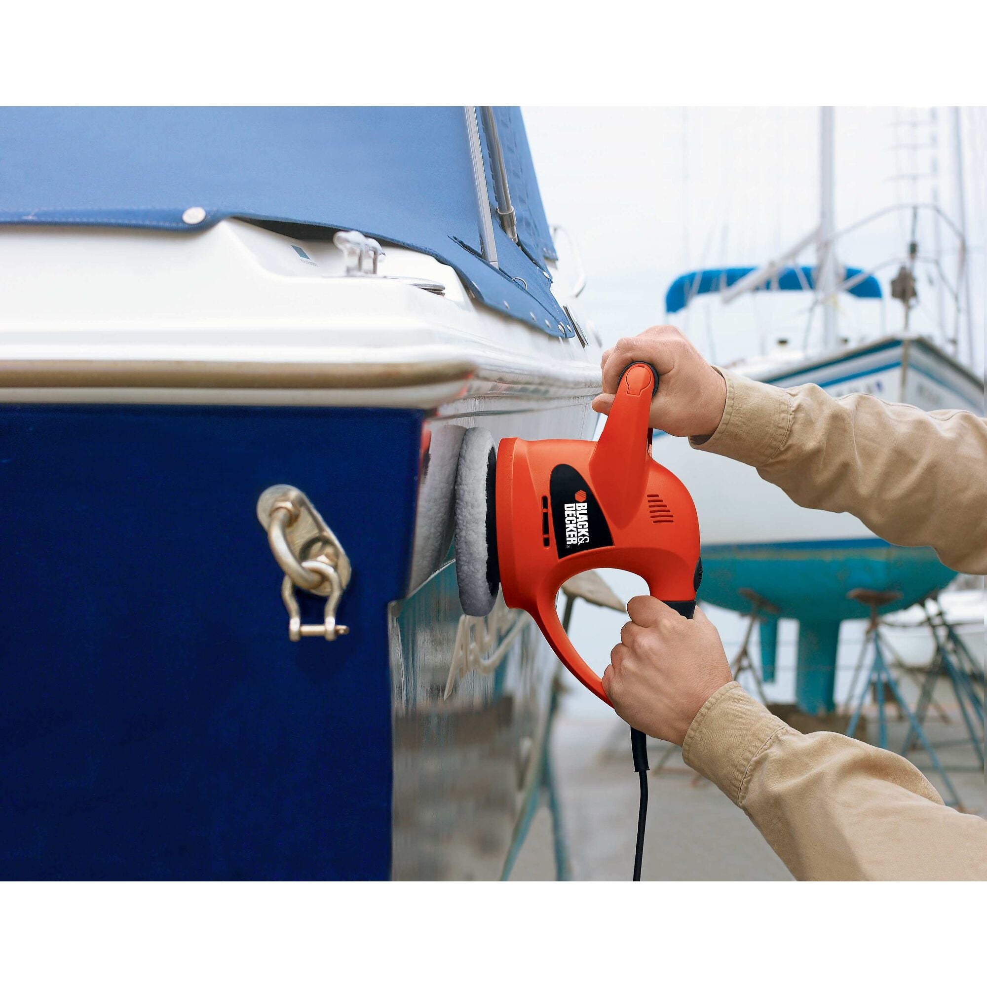 BLACK+DECKER Variable Speed Polisher is polishing the outside surface of the blue boat.