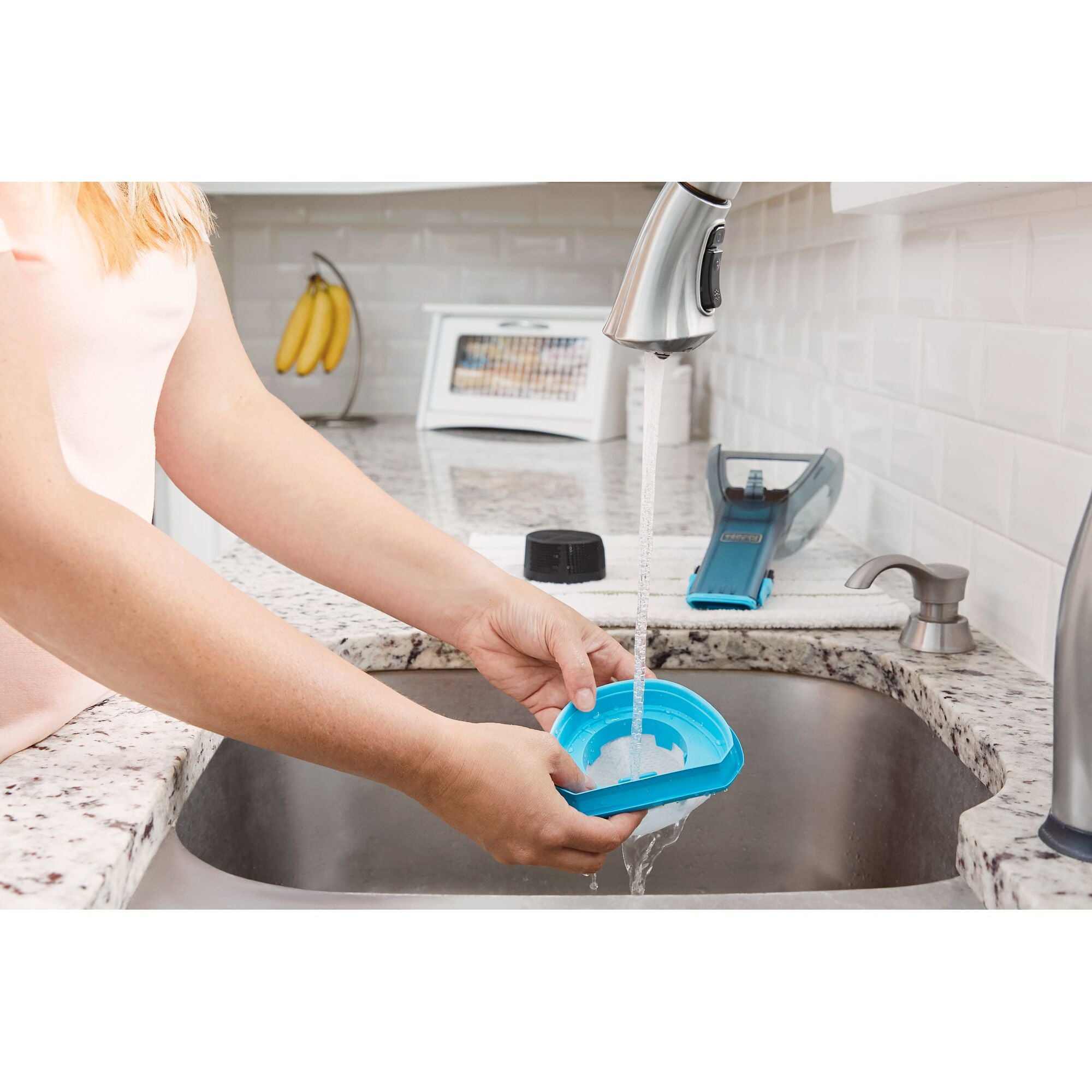BLACK+DECKER dustbuster® Detailer Cordless Hand Vacuum filter being washed under running water