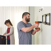 Lithium ion drill and driver being used by a person to drill a tv frame into the wall.