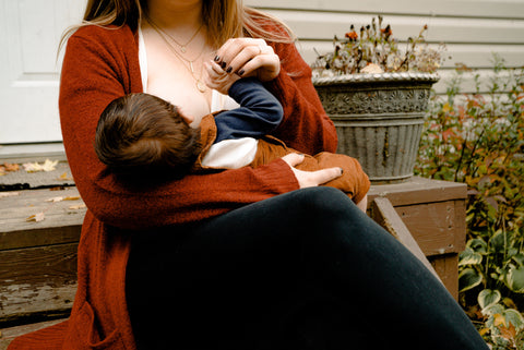 A new mother is feeding to her newborn baby