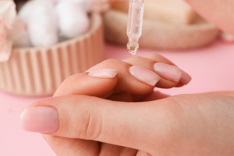 Cuticle oil being applied to a nail