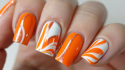 Bright orange nails with an unusual white pattern
