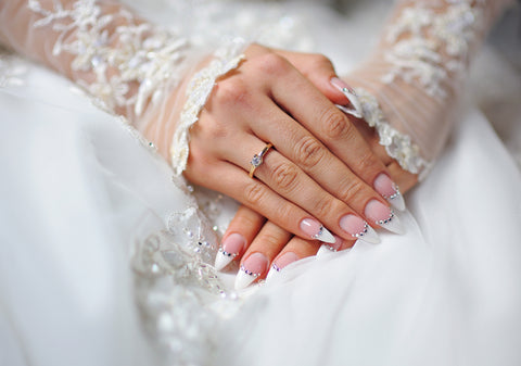 Bride with hands overlapping with well manicured nails