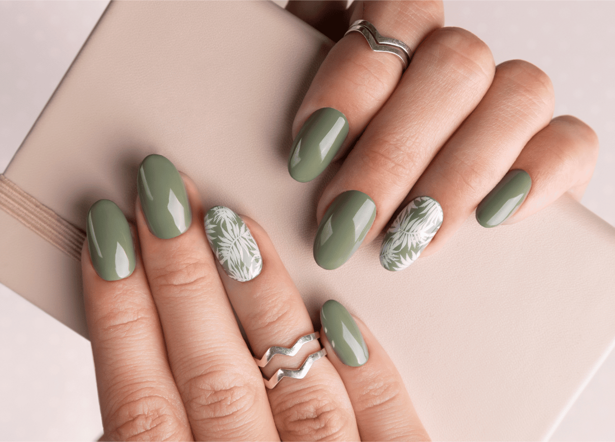 Green nails with a white pattern design