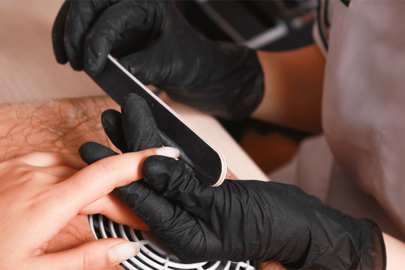 Nails being filed with nail file