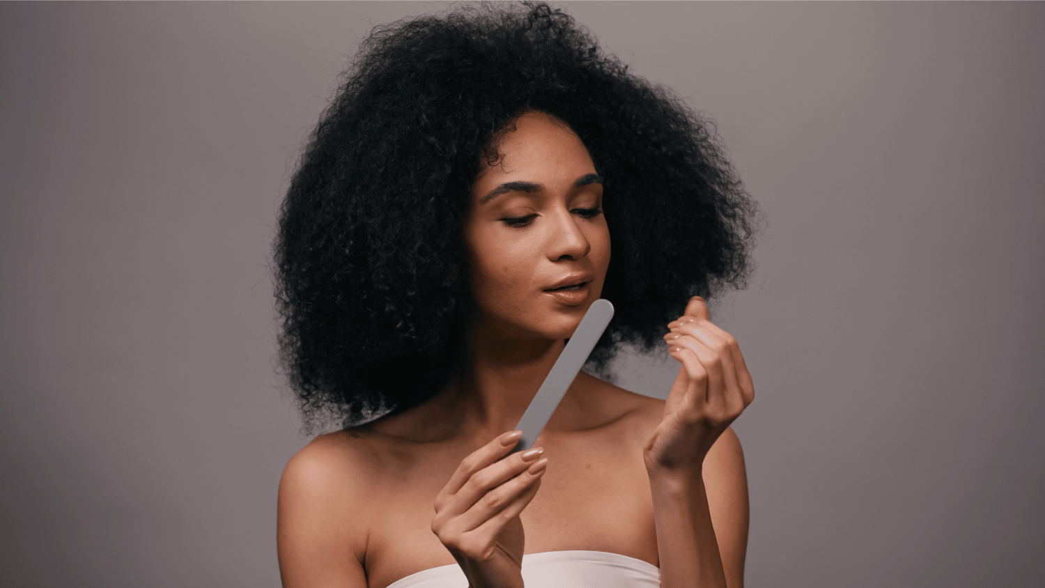 Woman using nail file