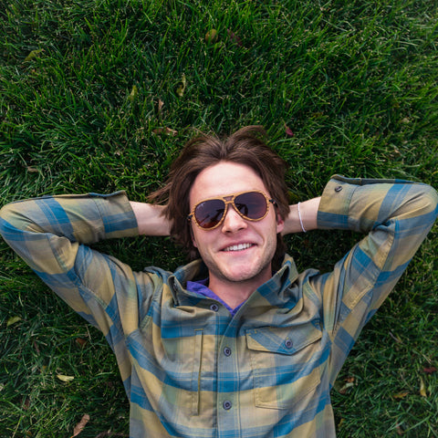 Dan of Stringies lying in grass field so happy that he is wearing Stringies