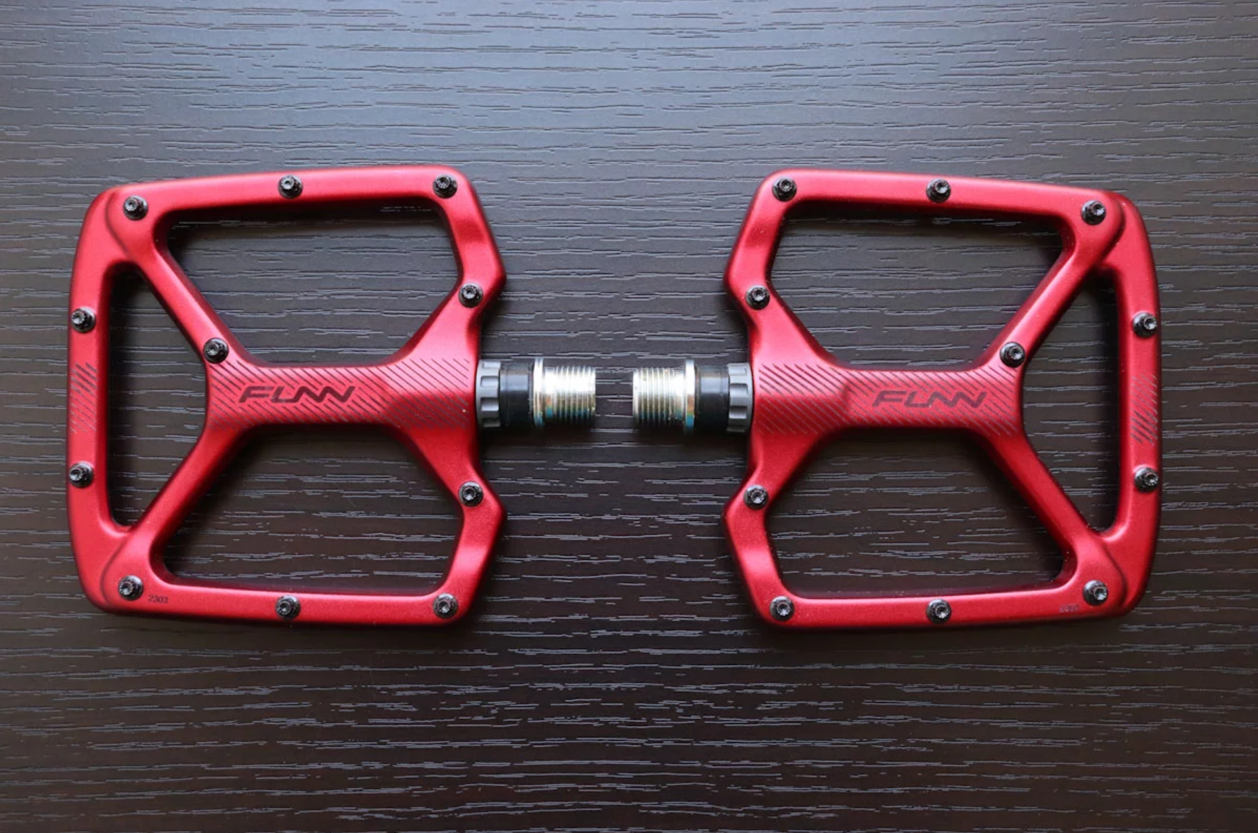 a pair of red python pedals on a table
