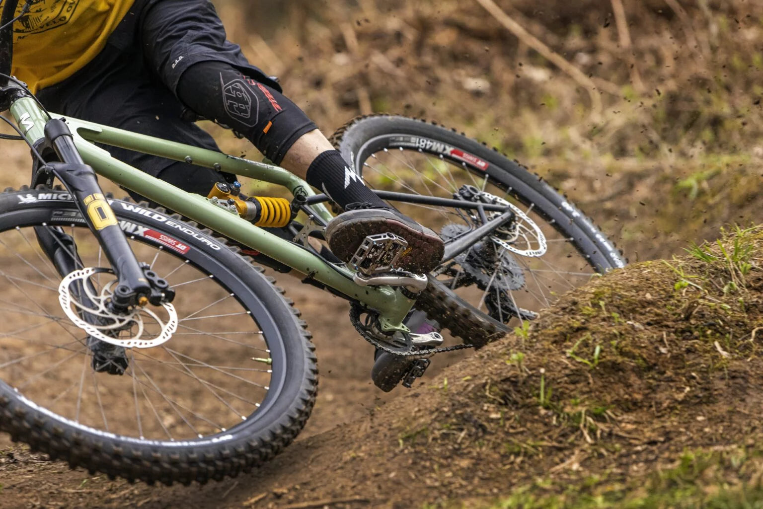 A man riding a mountain bike on a dirt trail.