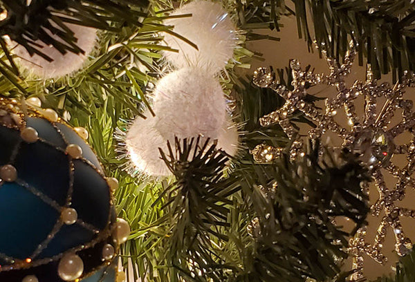 Use reflective ornaments toward the center of the tree