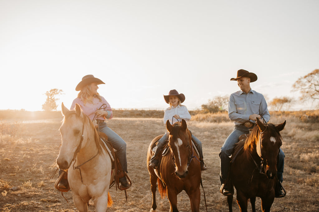 Man woman and child on horses