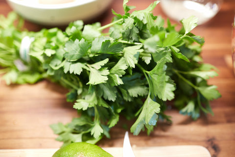 Close-up picture of parsley on a wood cutting board