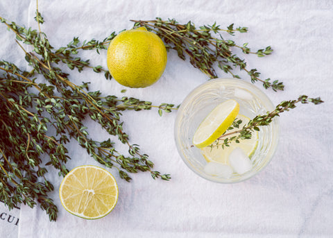Thyme and lemons on a white sheet