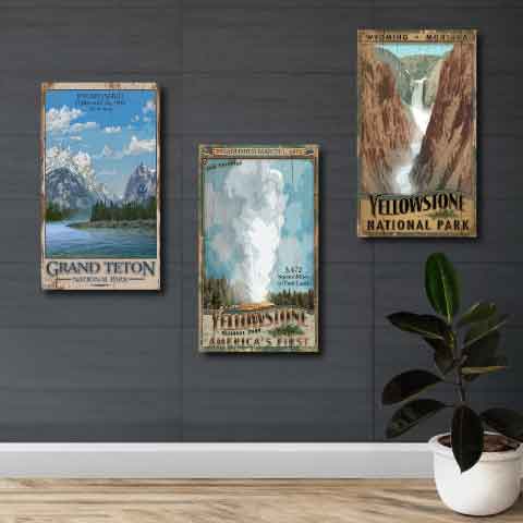 Grand Teton, Yellowstone and Old Faithful national park vintage signs on grey wall.