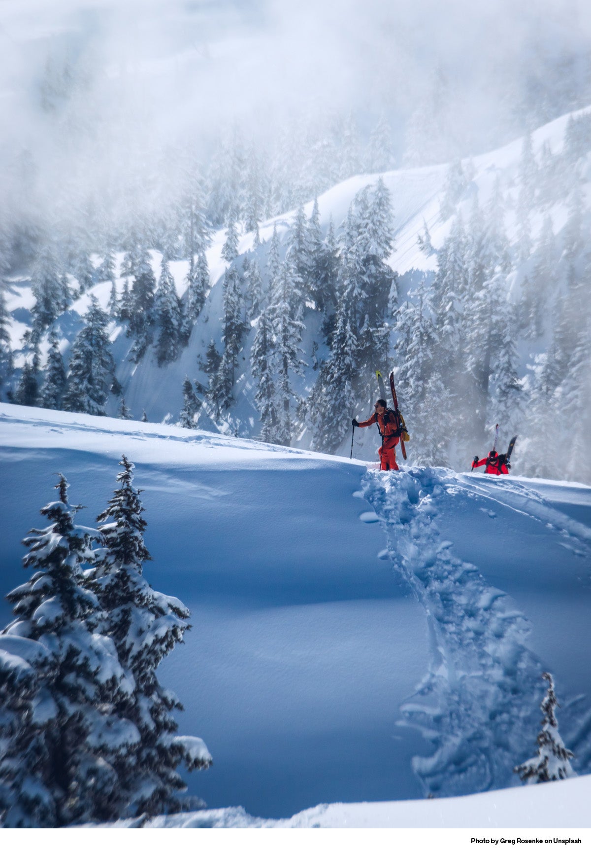 Skiers ascending a mountain in British Columbia, Canada.