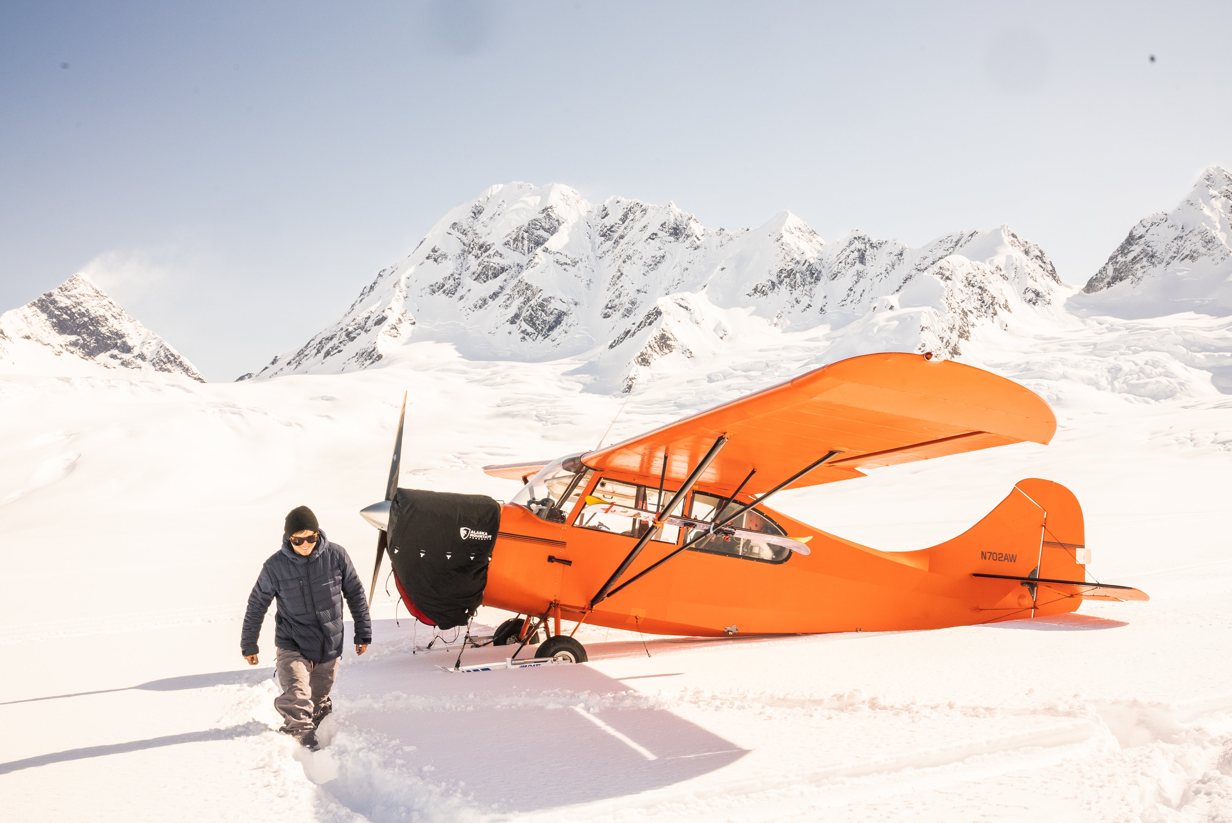 Andrew Muse walking away from an airplane in Alaska