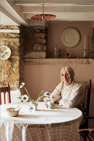 Victoria Barker sat at a vintage table looking at the camera