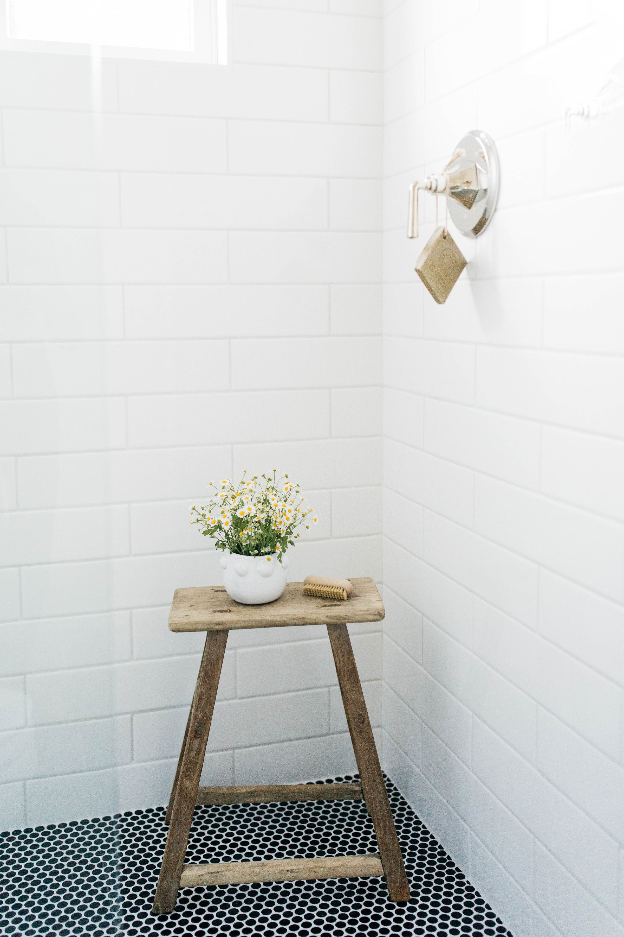 Albion project greige design shop + interiors Point Loma San Diego California interior design bathroom black penny tile white subway tile vintage wood stool