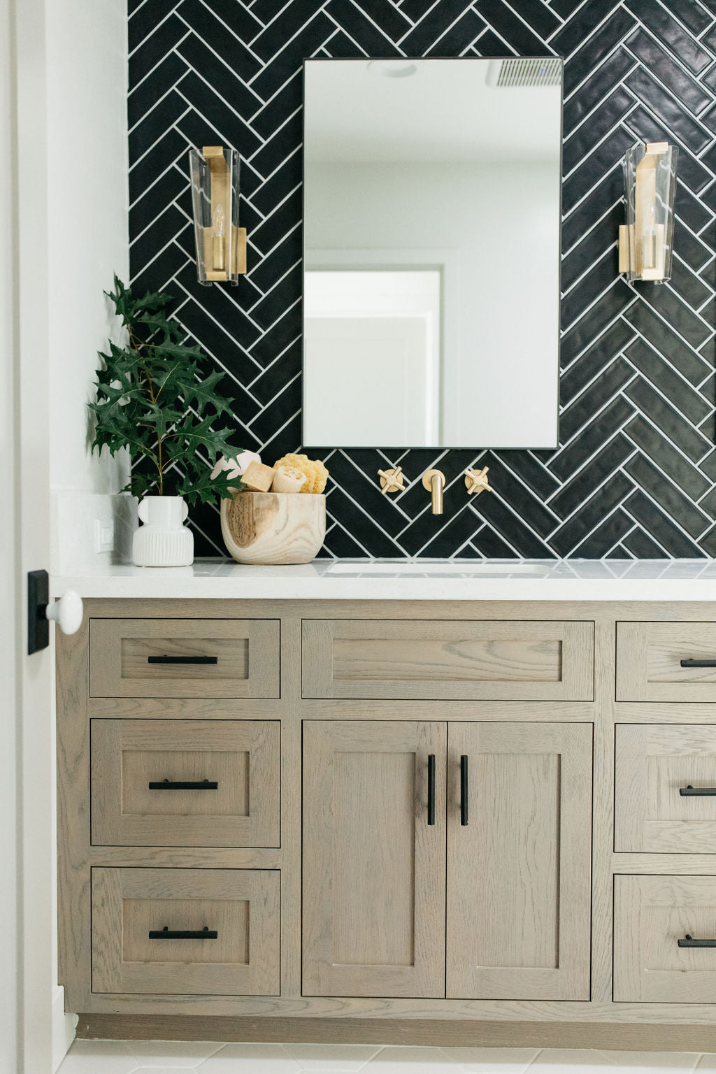 greige design shop + interiors alexandria project san diego california beach house black herringbone backsplash brass fixtures master bathroom design