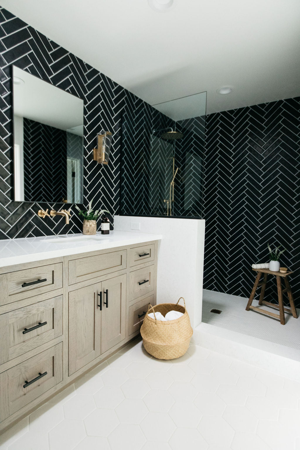 greige design shop + interiors alexandria project san diego california beach house black herringbone backsplash brass fixtures master bathroom design