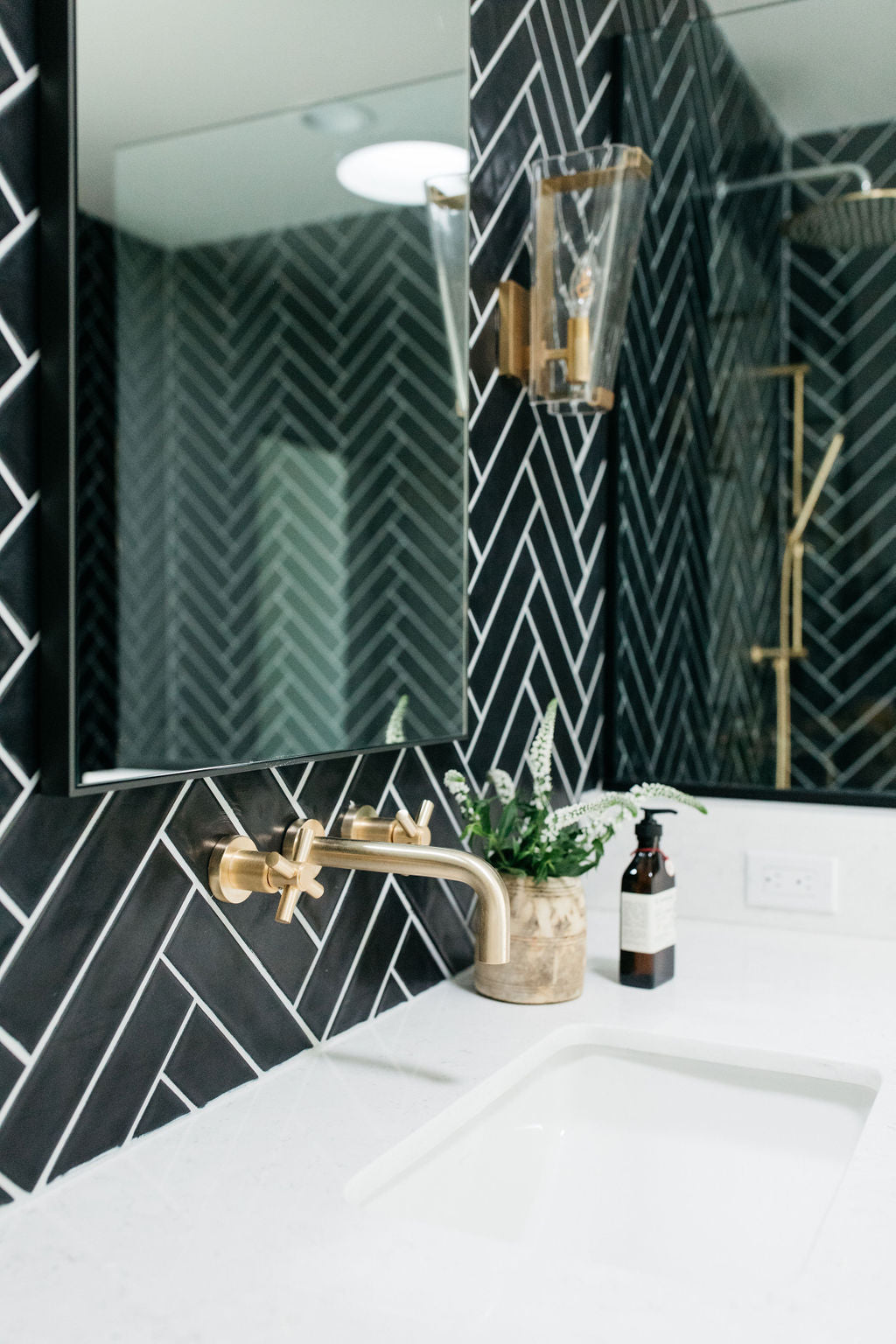 greige design shop + interiors alexandria project san diego california beach house black herringbone backsplash brass fixtures master bathroom design