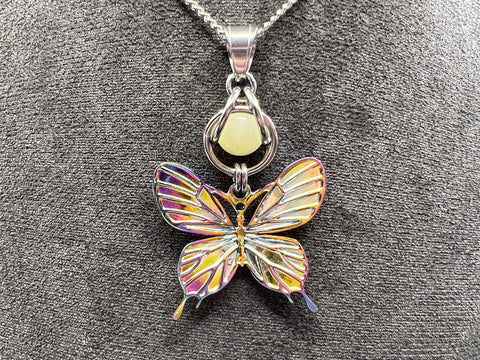 rainbow stainless steel butterfly pendant with a serpentine bead hanging above it