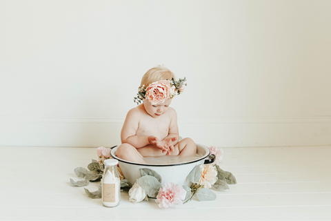 toddler in milk bath