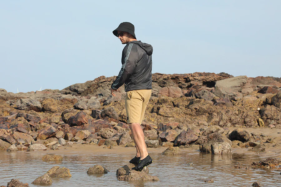 With a resistant rubber outsole, the man stands on the rock.