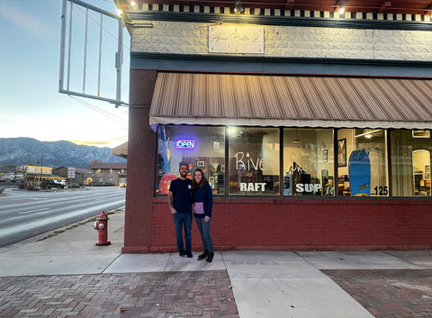 Owners of river station gear in front of the outdoor gear store in canon city, colorado