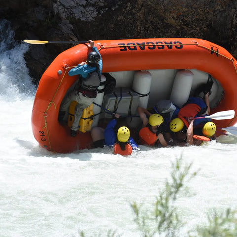 Flipping a raft with river station gear. Pictured items are dry thwart bag and throw bag for whitewater rafting. 