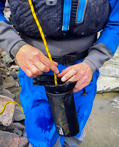 Stuffing a River Station waist throw bag for whitewater rafting and kayaking.