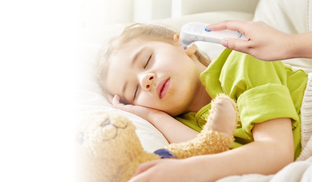 Ear thermometer being used on the child's ear