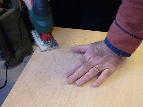 Close up of man cutting wood with a jigsaw