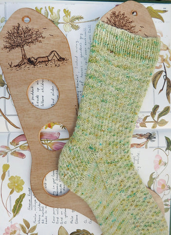 Hand knitted sock on a sock blocker