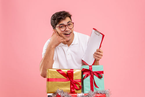 front-view-young-man-around-xmas-presents-holding-file-note-pink-wall.jpg__PID:0f0c0335-2d91-49ea-9f4a-dc6dea28b12c