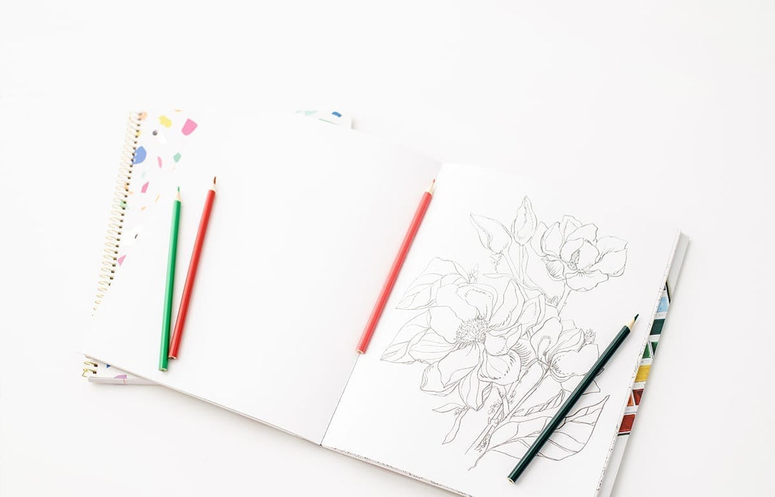 coloring book featured uncolored floral page and colored pencils